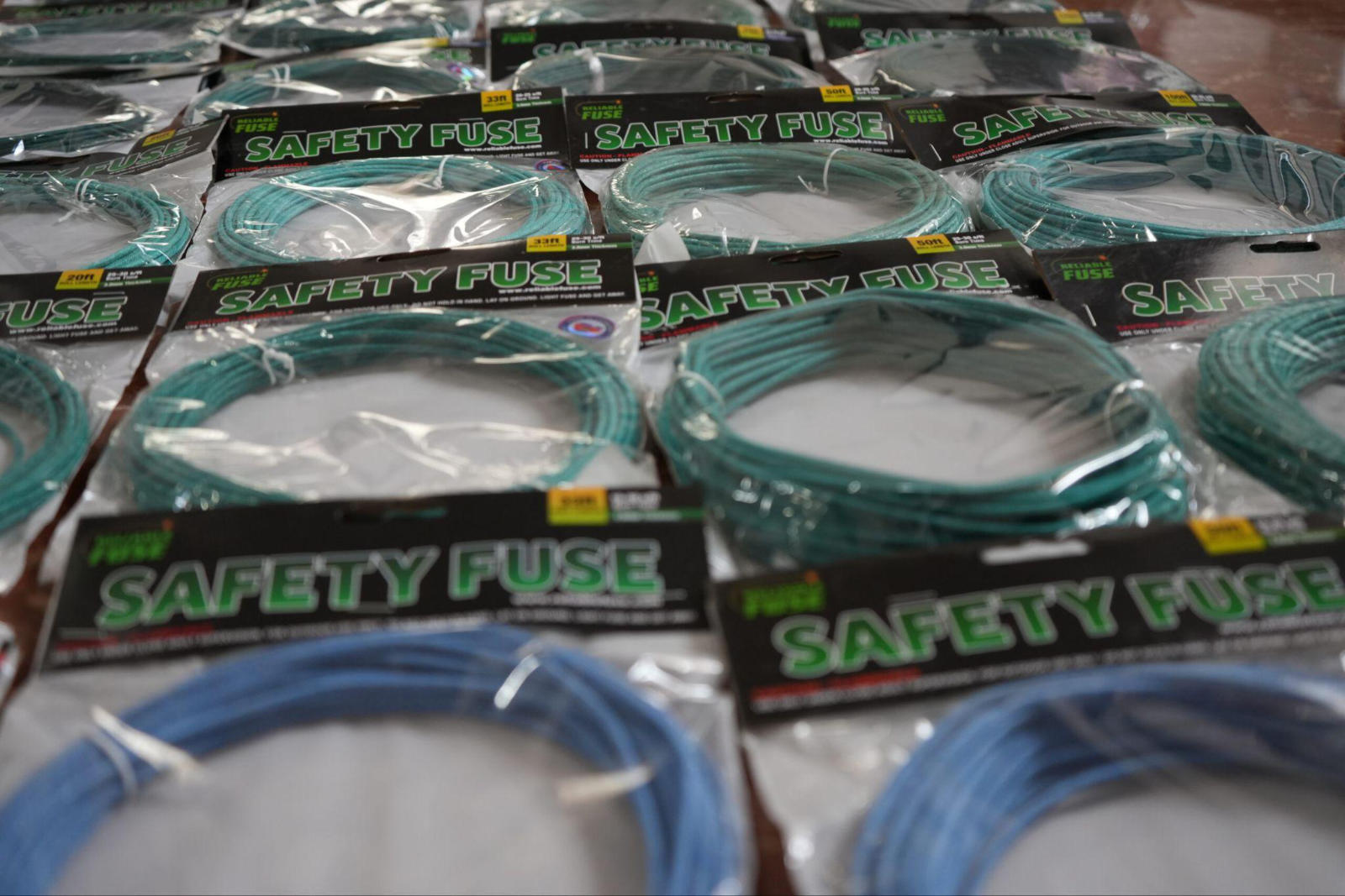 Grid arrangement of various packaged Visco safety fuses showcasing different roll lengths, colors, and specifications.