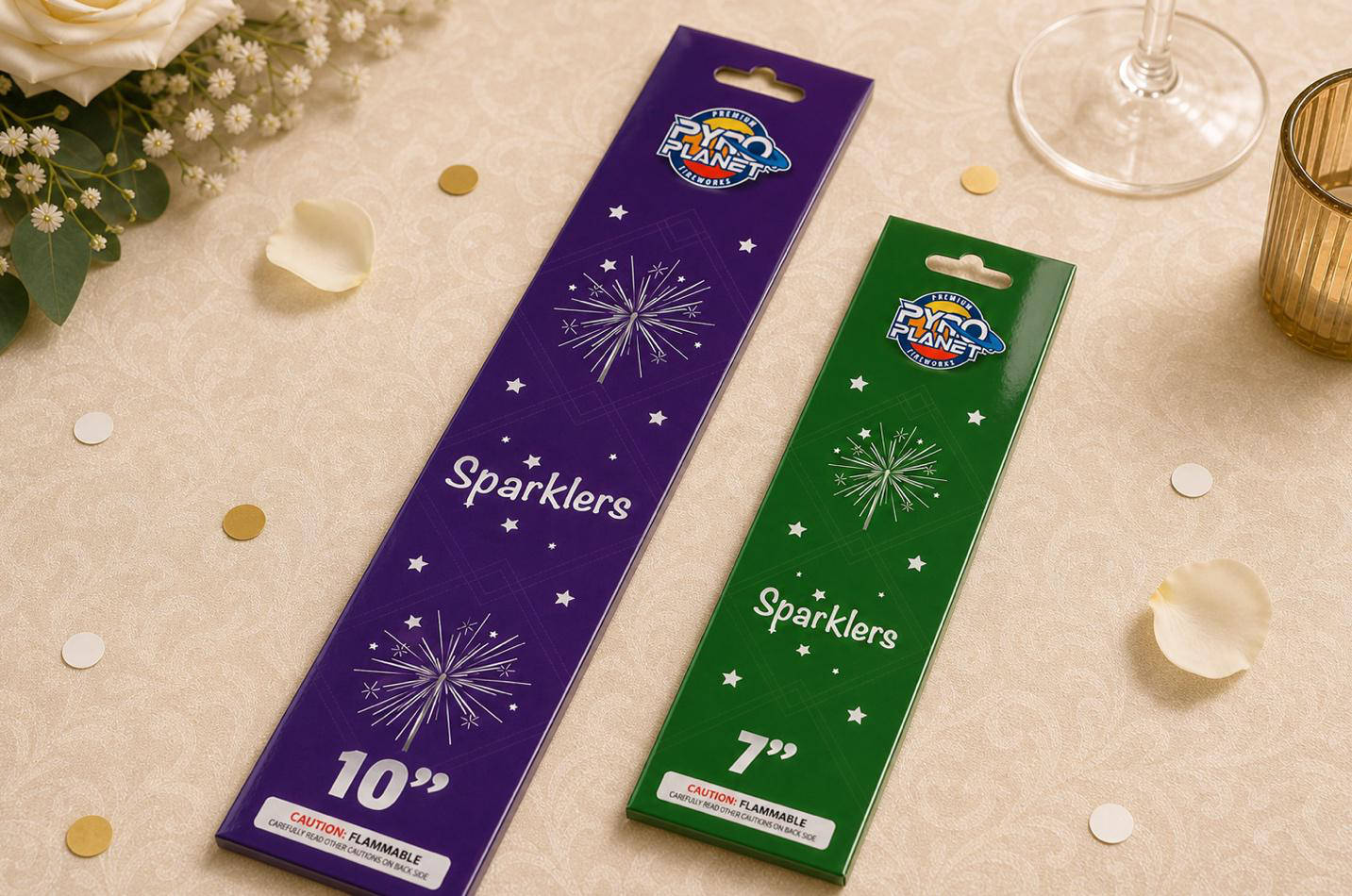 Packages of Pyro Planet 7-inch green sparklers and 10-inch purple sparklers displayed on a wedding table setup.